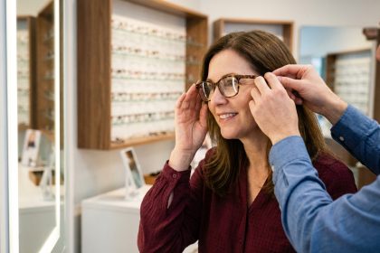 Femme essayant des lunettes chez un opticien à Bourbourg dans une boutique moderne